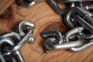 Sometimes you just have to let go. Shot of metal chains with a broken link.